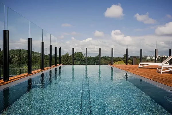 Das Bild zeigt die Rooftop-Bar und den Infinity Pool des Hotels Radisson Resort Hotel Kolberg mit Blick ins Grüne